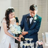 Bride and Groom Cutting Wedding Cake at Reception